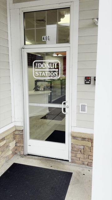 The front door of the Wethersfield shop at 486 Silas Deane Hwy, with The Donut Station logo on the glass