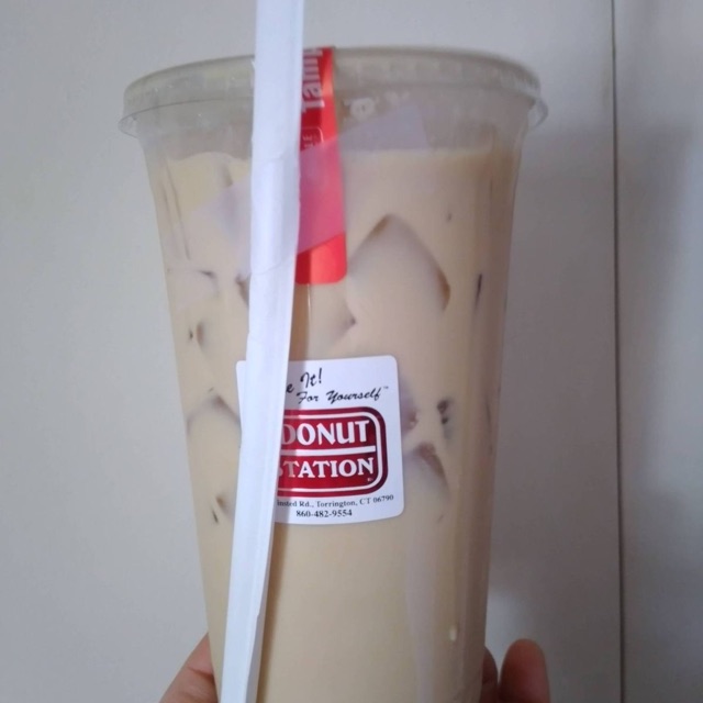 A 32-ounce iced coffee in a clear Donut Station cup